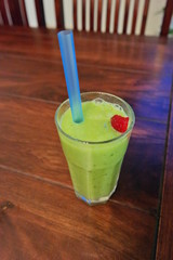 a glass of green vitamin shake