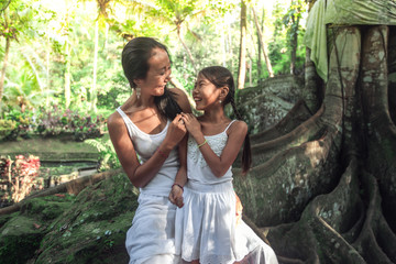 Mother with daughter spend time together in nature park