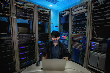 Engineer configure data center on laptop.