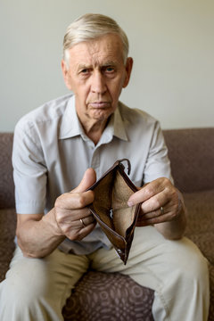 Sad Old Man Holding An Empty Wallet.