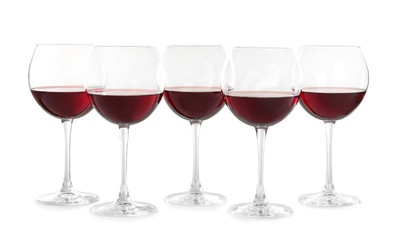 Glasses with red wine on white background