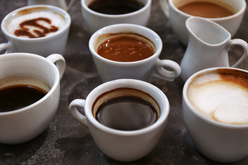 Cups of fresh aromatic coffee on grey background
