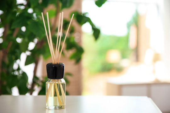 Aromatic reed air freshener on table indoors