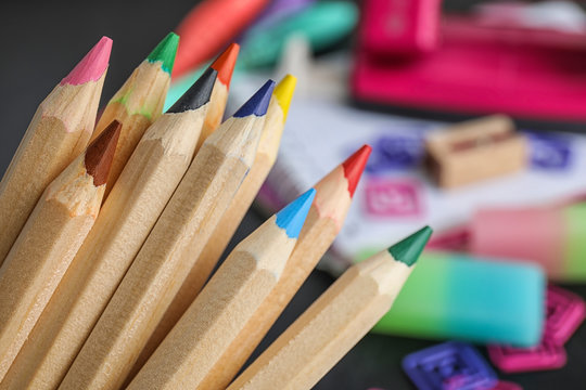 Colorful pencils against blurred background. School stationery