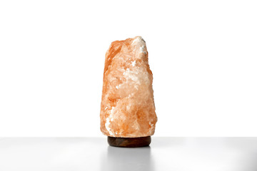 Exotic Himalayan salt lamp on white background