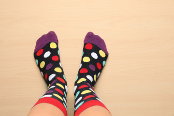 Woman wearing stylish socks standing on floor, top view. Space for design