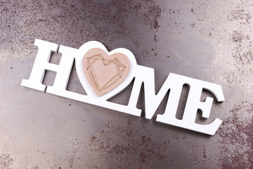 The word Home in white letters isolated on rusty background