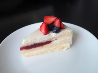 Strawberry cake dessert bakery with fresh strawberry and blueberry and strawberry jam on white plate.