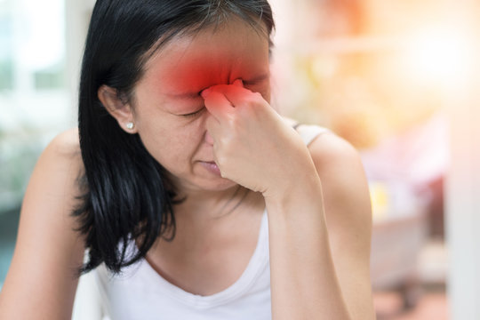 Sinus,Sinusitis, or rhinosinusitis concept. Asia woman suffer from headache, thick nasal mucus, and face pain symptoms.