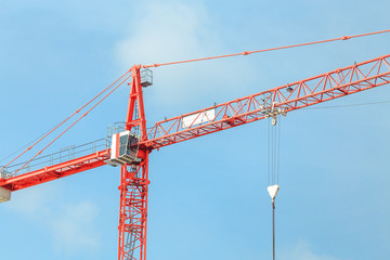 Construction tower cranes against blue sky background