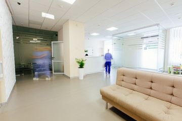 Empty white hall in the modern office gynecologycal clinic building. Motion blur