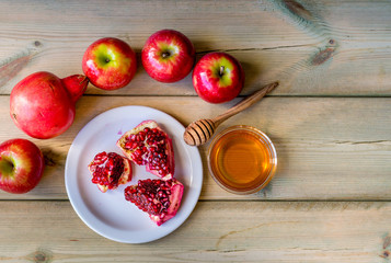 Apple and honey on wood deck, traditional food of jewish New Year - Rosh Hashana.