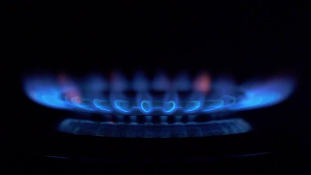 Gas stove ignites on a black background