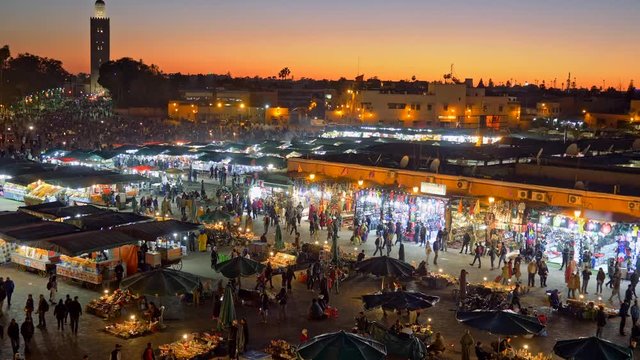 Jamaa el Fna (Jemaa el-Fnaa) in the evening. Marrakesh, Morocco. Zoom out shot