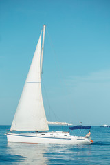 Naklejka premium Beautiful luxury yacht with white sails is for those who truly know how to live.