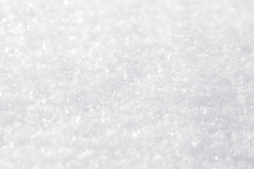 Shiny white background. A snow texture on a winter sunny day.