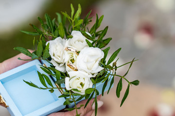 stylish golden wedding rings in a box and modern bouquet . luxury rings with diamond and fresh flowers on wedding morning .