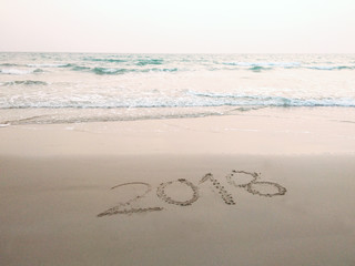 2018 on tropical beach and sea wave is coming on the sand background
