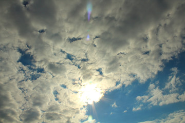 Beautiful sky and sunlight. Layered and cumulus white gray clouds. Background. Landscape.