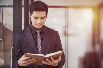 Portrait of a businessman reading a book