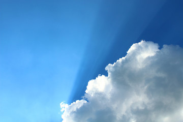 Beautiful white cumulus clouds and sun rays. Background. Landscape.
