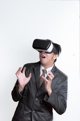 Asian Businessman wearing virtual reality on white background