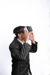 Fototapeta premium Asian Businessman wearing virtual reality on white background