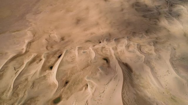 Panoramic movement in the sand.  Flight over the barkhans in the desert.