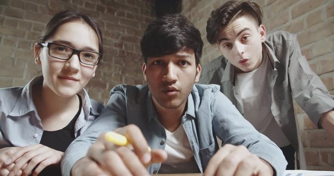 three students delighted or surprised with success of their project. teens descovering results of exams. education, friendship concept 4k