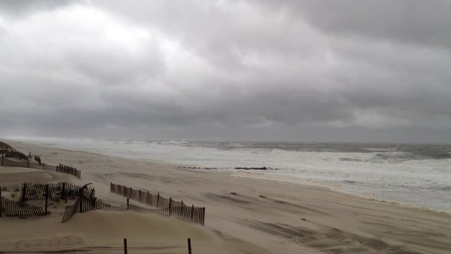 Stormy weather at the beach shows moody clouds and choppy waves.