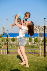 Obraz premium the sister raises her brother above her. Laughter, the game.
