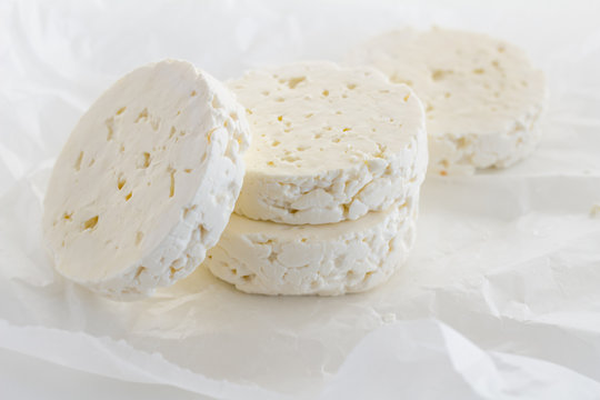Feta cheese rounds on parchment paper