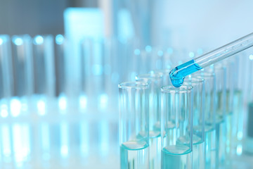 Dripping reagent into test tube with sample at laboratory, closeup. Chemical analysis