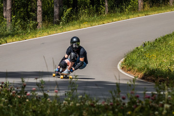 Longboard downhill rider make fast in a turn