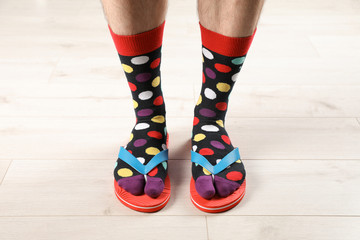 Man in socks and slippers on floor, closeup