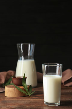 Glassware with hemp milk on wooden table