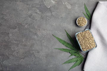 Fotobehang Flat lay composition with hemp seeds and space for text on grey background © New Africa