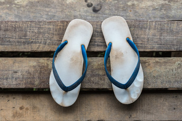 Sandal or flip-flop blue color on wooden staircase