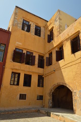 Fototapeta na wymiar Old Fortress Turned Into Precious Houses In The Port Of Chania. History Architecture Travel. July 6, 2018. Chania, Crete Island. Greece.