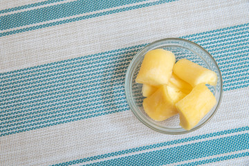 Transparent bowl with manioc on striped background - Top view
