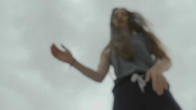 female dancer with long hair performing hip hop snake moves in slowmotion. 