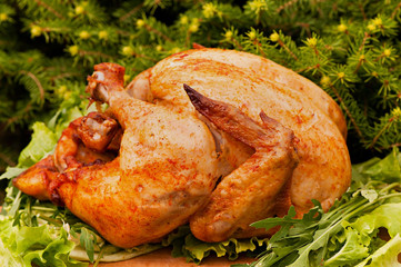 Baked turkey with cherry tomatoes on a Christmas background. Natural food cooked on the grill.