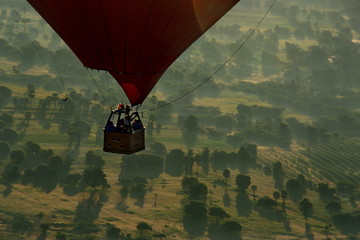 Bagan. Myanmar. 11/25/2016. Every morning at dawn, a dozen balloons carrying tourists rise together...
