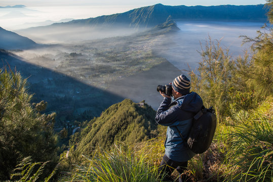 A man traveler with shooting photo amazing nature near  of  Mount BROMO at indonesia