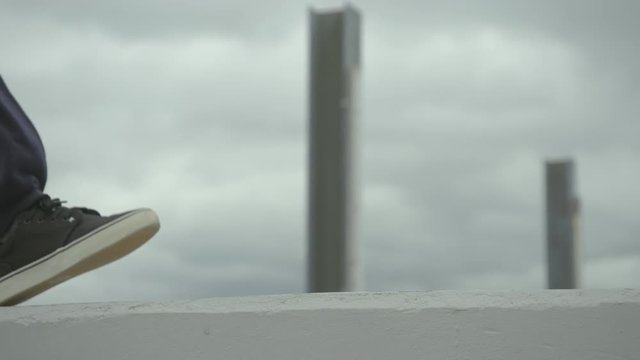 dancer performs a jump off of a concrete wall