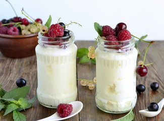 Homemade yoghurt with different berries and mint in a jar