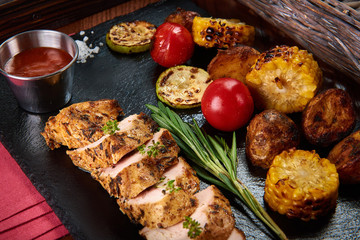 Chicken fillet and grilled vegetables with tomato sauce