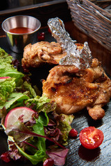 fried chiken and vegetable salad on a tray