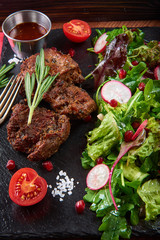 fried meat and vegetable salad on a tray