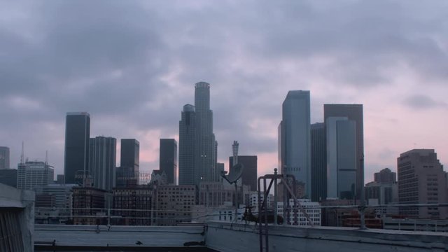 TImplClouds roll over the skyscrapers of downtown los angeles around sun set
